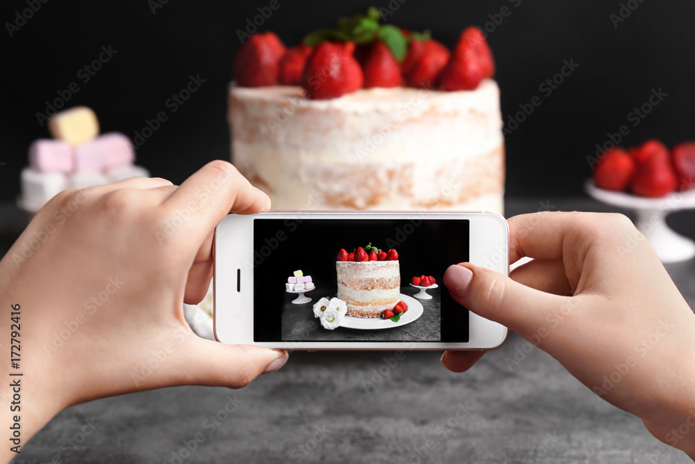 Blogger making photo of strawberry cake