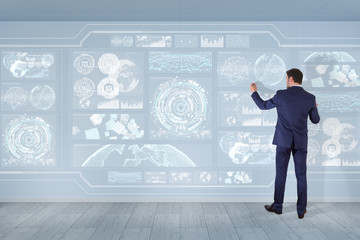 Poster - Businessman using graph screens interface on a wall 3D rendering