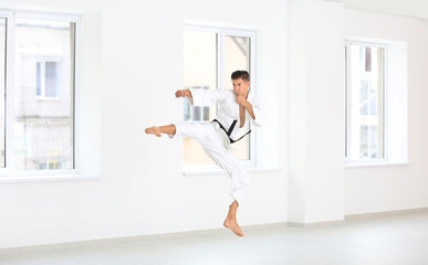 Wall Mural - Male karate instructor training in dojo