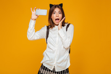 Wall Mural - Shocked young teenage schoolgirl in uniform