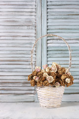 Wall Mural - Dried roses in basket against blinds