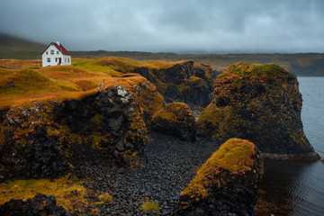 Landscape of Iceland, lonely house on the ocean, fog and rain. A journey into a far country