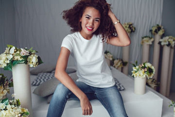 Wall Mural - Curly haired girl with freckles in blank white t-shirt. Mock up.