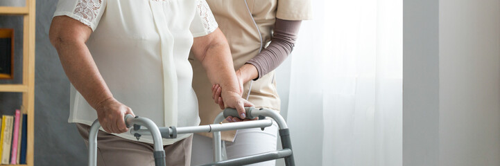 Canvas Print - Assistant supporting elderly woman