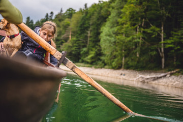 Wall Mural - Mother and daughter with a dog rowing a boat