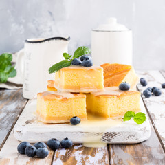 Wall Mural - Traditional homemade baked pudding cake with custard cream and blueberries. Healthy dessert.