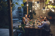© Lumina/Stocksy - Friends Having Dinner in The Yard
