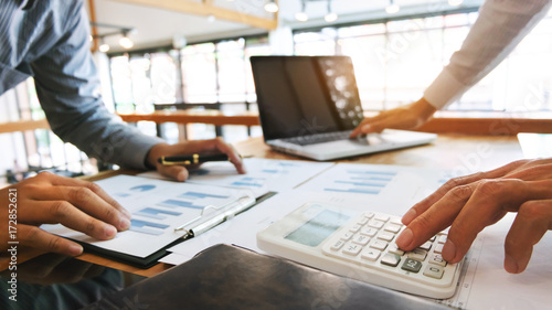 Plakaty do biura rachunkowego business-executives-analysis-data-document-and-calculating-about-fee-tax-at-a-office