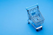 © ink drop - Shopping cart on a blue background