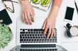 © BONNINSTUDIO/Stocksy - Woman's hands typing on laptop from above.