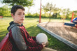 © Courtney Rust/Stocksy - Teen boy holding a volleyball at park