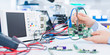© luchschenF - Female laboratory assistant Repairs PCB module for CNC robotics. Measurement of the parameters of the electronic system in the laboratory