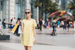 © Lumina/Stocksy - Blonde Woman Carrying Shopping Bags on the Street