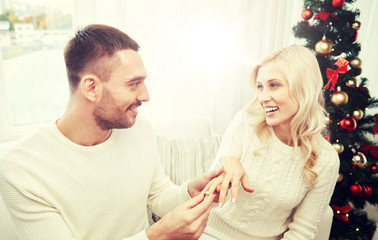 Poster - man giving engagement ring to woman for christmas