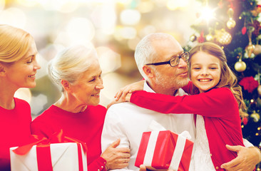 Canvas Print - happy family with christmas gifts over lights