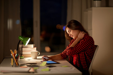 Wall Mural - tired student or woman touching neck at night home