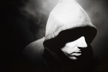 Portrait Of Man Wearing Hoodie In Dark Alley, Shadow Across Face