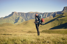 Female Hiker Viewing The Journey Ahead, Standing At The Base Of A Mountain