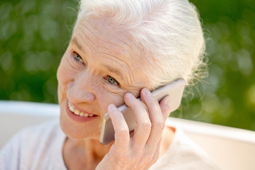 Poster - happy senior woman calling on smartphone in summer