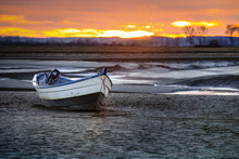 Selective Focus On Boat On Sand At Low Tide With Sunset, Grain Texture Apply 