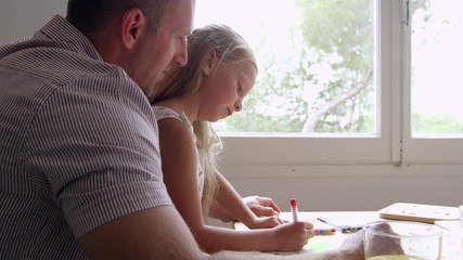 Wall Mural - Daughter With Father Drawing Picture At Table Shot On R3D