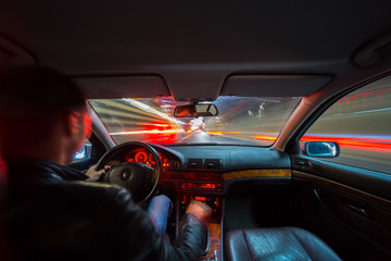 Wall Mural - City road view from inside car natural light street and other cars is motion blurred