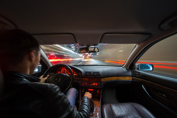 Wall Mural - City road view from inside car natural light street and other cars is motion blurred