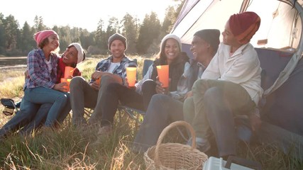 Wall Mural - Multi generation family on camping trip sit outside tent 