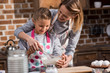 © LIGHTFIELD STUDIOS - mother helping daughter with cooking