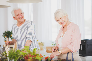 Wall Mural - Smiling old couple prepare a meal