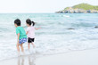 © TinPong - Young little girl and boy on the beach