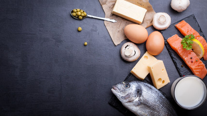 Black table with ingredients of food rich in vitamin D and omega 3, with copy space.