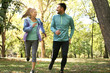 Young couple running together in park. Young people exercising.
