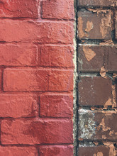 Vivid Red Paint Covering Graffiti On Brick Wall, Close Up