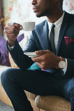 Close Up Of Elegant Black Man Sitting In Stylish Living Room And Drinking Espresso