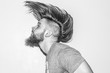 © Igor Madjinca/Stocksy - hair in motion,handsome young man with a beard and piercing