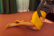 Young Lady Sitting On The Floor Of The Room With Carpeting
