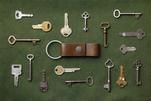 Keys Arranged Around A Key Chain On Green Canvas Fabric