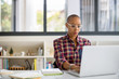 © Jovo Jovanovic/Stocksy - Young serious looking woman typing on laptop