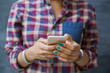 © Jovo Jovanovic/Stocksy - Close up of a young woman's hand typing text message on her smartphone