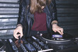 © Danil Nevsky/Stocksy - Young female DJ playing music at DJ desk