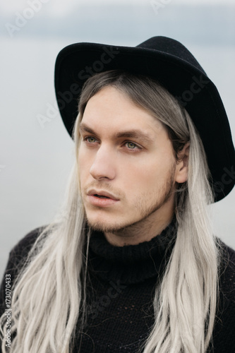 Portrait Of A Male Model With Long Hair And Black Hat Buy This