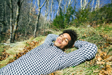 Man Enjoying A Sunny Day Lying On Grass.
