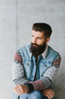 © Amir Kaljikovic/Stocksy - Handsome trendy bearded young man