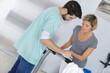 © auremar - physiotherapist helping patient walking rehabilitation