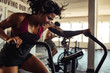 © Jacob Lund/Stocksy - Fitness female using air bike for cardio workout