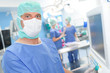© auremar - portrait of surgeon standing in operation room at the hospital