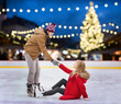 © Syda Productions - man helping woman on christmas skating rink