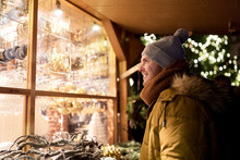 Happy Man Looking At Christmas Market Shop Window