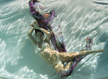 Young Woman In A Crochet Swimsuit Underwater.